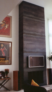 Fireplace sheathed in raw steel plate